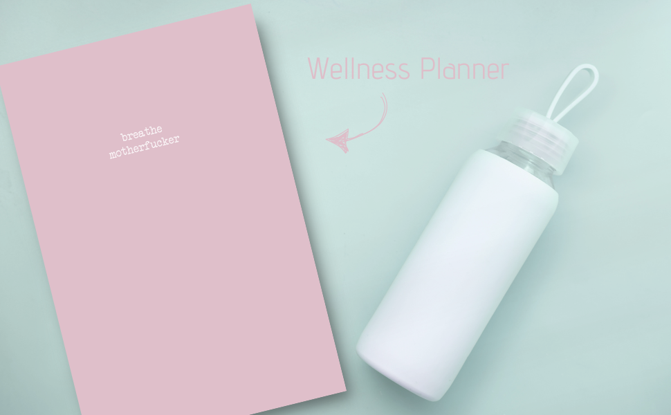 Pink wellness planner and white water bottle on a light green background