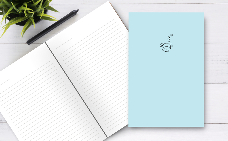 puffer fish with bubbles spelling out 'cunt' on a desk with the inside pages, a pen and a plant