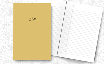 A yellow notebook with a simple black line drawing of a cute little frog on the cover with the words 'Brain frog', inside lined pages.